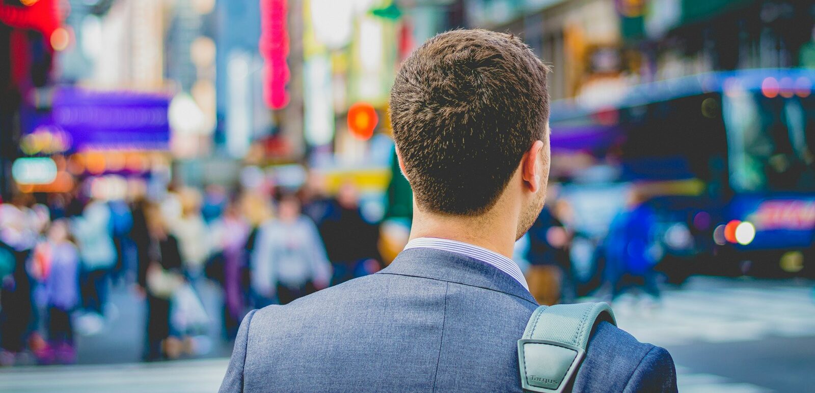shallow focus photography of man in suit jacket's back